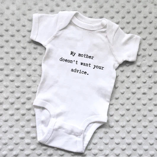 White baby onesie with printed text “My Mother Doesn't Want Your Advice” on the front.