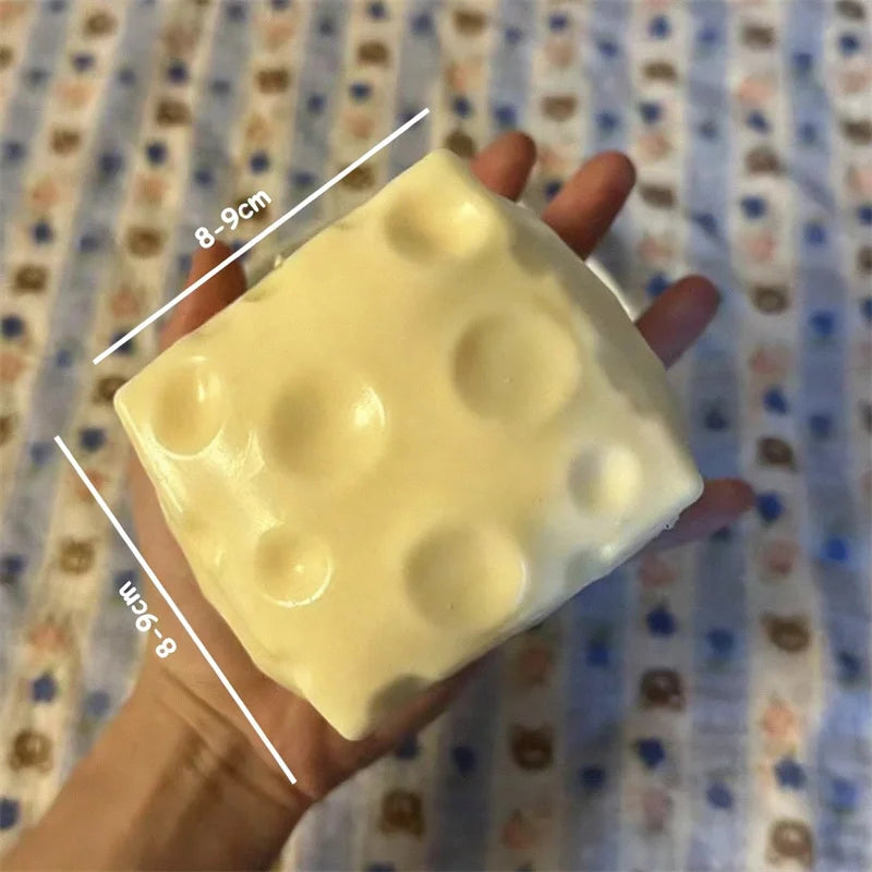 Close-up of a cheese-shaped stress ball with textured surface details.